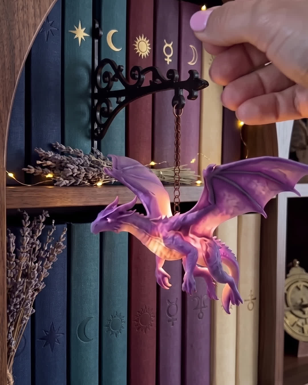 Floating Dragon bookshelf lamp glowing on a dark gothic library shelf